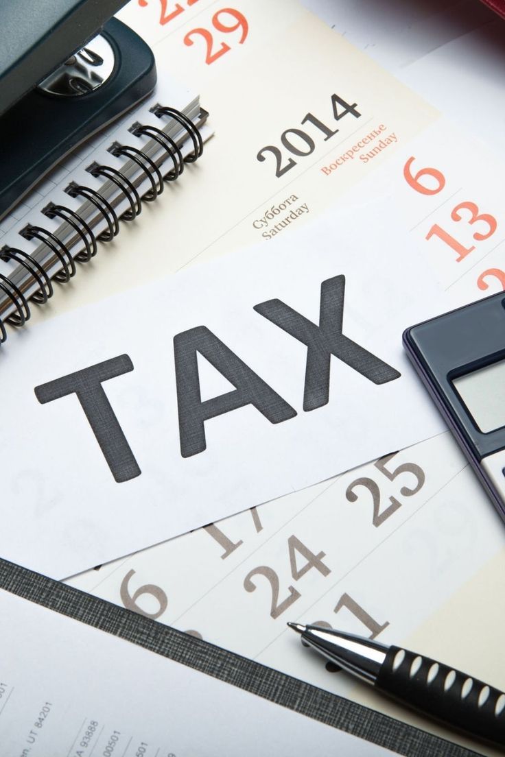 Tax paperwork beside a calendar